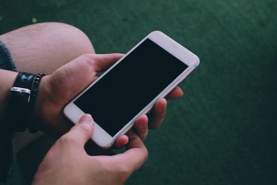 Midsection of man using mobile phone