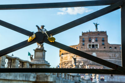 Low angle view of bridge and buildings against sky