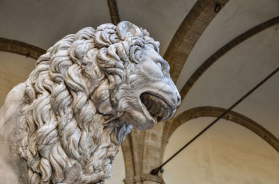 Low angle view of statue against wall