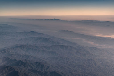 Scenic view of snowcapped mountains against sky during sunset