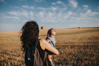 WOMAN STANDING IN FIELD