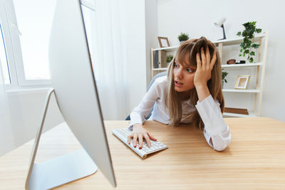 Portrait of young woman working at home