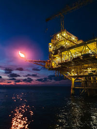 Offshore oilfield oil and gas platform after sunset at bluehour