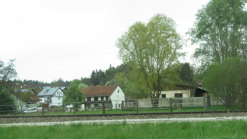 Houses on field against clear sky