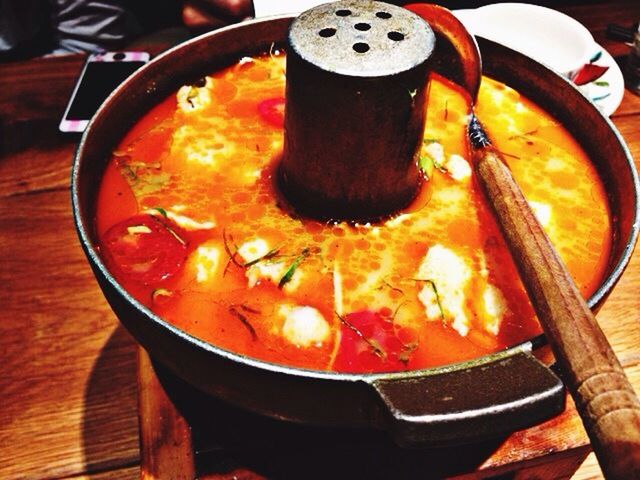 heat - temperature, flame, burning, fire - natural phenomenon, orange color, food and drink, indoors, high angle view, close-up, still life, preparation, table, wood - material, glowing, cooking, fire, food, freshness, container, no people