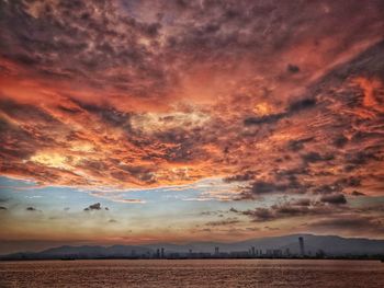 Scenic view of dramatic sky over sea during sunset