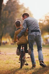 Father and son with bicycle in park