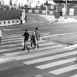 Men walking on road in city