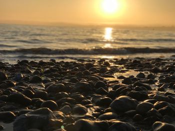 Close-up of sea against sky during sunset