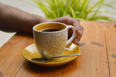 Close-up of coffee cup on table