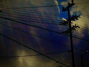 Low angle view of power lines against sky