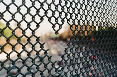 Close-up of chainlink fence against sky