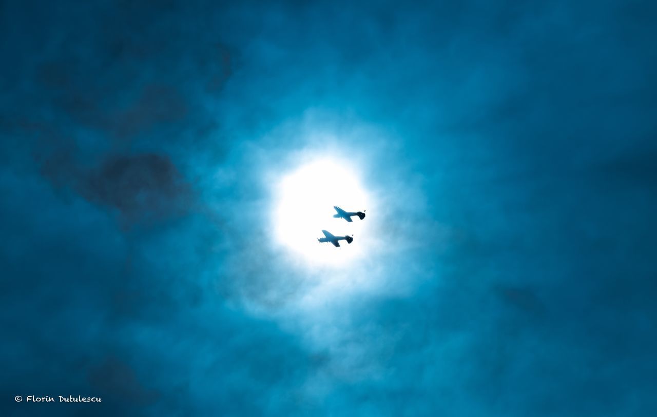 low angle view, sky, cloud - sky, silhouette, nature, outdoors, blue, mid-air, day, beauty in nature, scenics, flying, no people