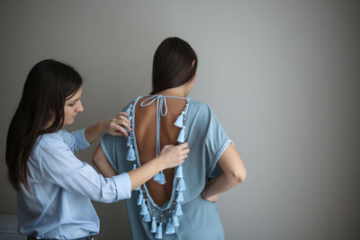 Seamstress tries on a tunic on the model, the concept of sewing business and small business, hobbies 