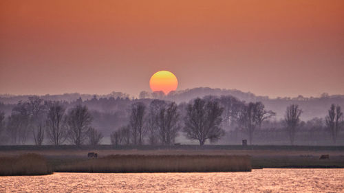 Scenic view of field against sky during sunset