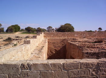 Panoramic view of stone wall against clear sky