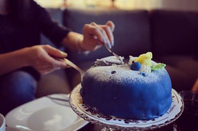 Close-up of woman holding serving cake