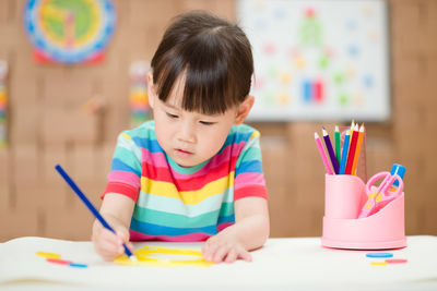 Young girl practice drawing different shapes for homeschooling