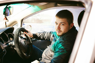 Portrait of man sitting in car