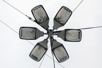 Low angle view of electric lamp against white background