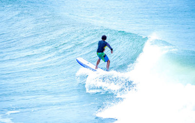 Full length of man surfing in sea