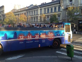 People on street against buildings in city