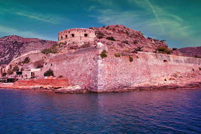 View of fort on mountain against cloudy sky