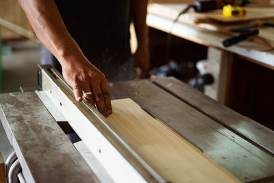 Midsection of man working on table