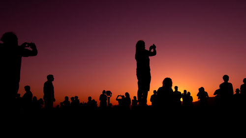 People taking photos during sunset