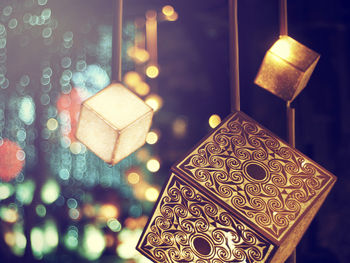 Close-up of illuminated lanterns hanging at night