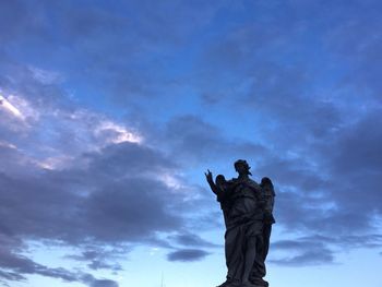 Low angle view of statue against sky