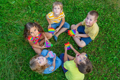 High angle view of cute girl playing with toys on grass