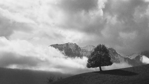 Scenic view of mountains against cloudy sky