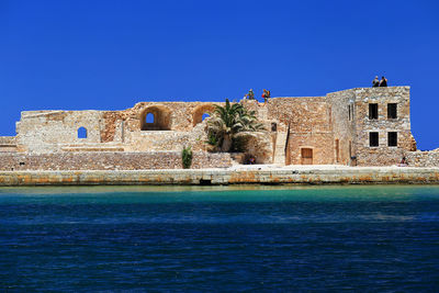 Low angle view of castle against clear blue sky