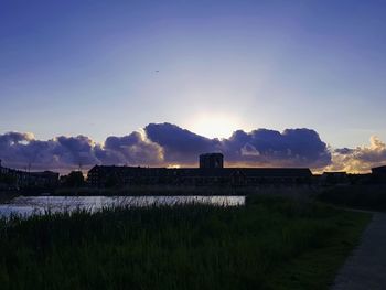 Scenic view of field against sky during sunset