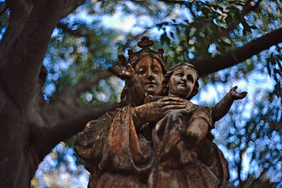 Low angle view of statue against trees