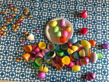 High angle view of colorful easter eggs with chocolates on table