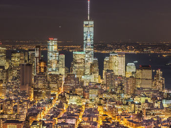 Aerial view of city lit up at night