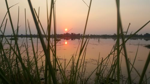 Scenic view of lake against sky during sunset