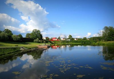 Reflection of town and trees in calm lake