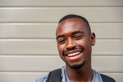 Portrait of afro young man smiling outdoors