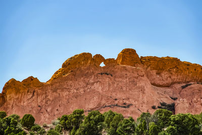 Low angle view of rock formations against sky