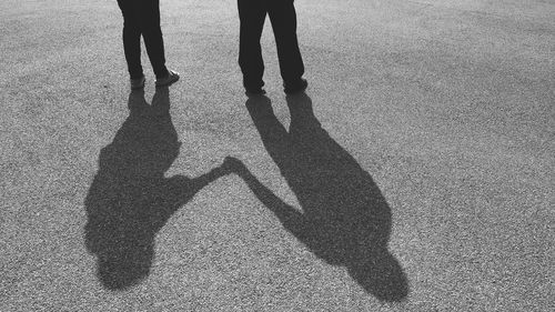 Low section of people shadow on street