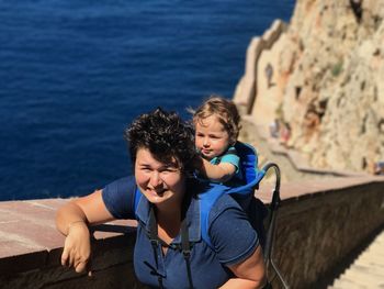 Portrait of woman carrying baby