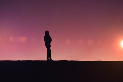 Man trekking in the countryside with a beautiful sunset background