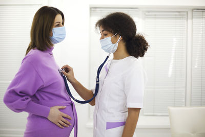 Female doctor examining patient in hospital