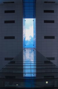 Low angle view of modern building against blue sky