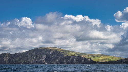 Scenic view of sea and mountains against sky