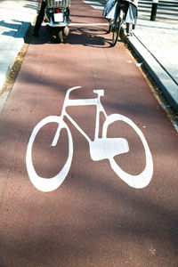 High angle view of bicycle lane sign on street