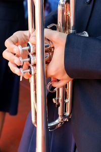 Midsection of man playing saxophone